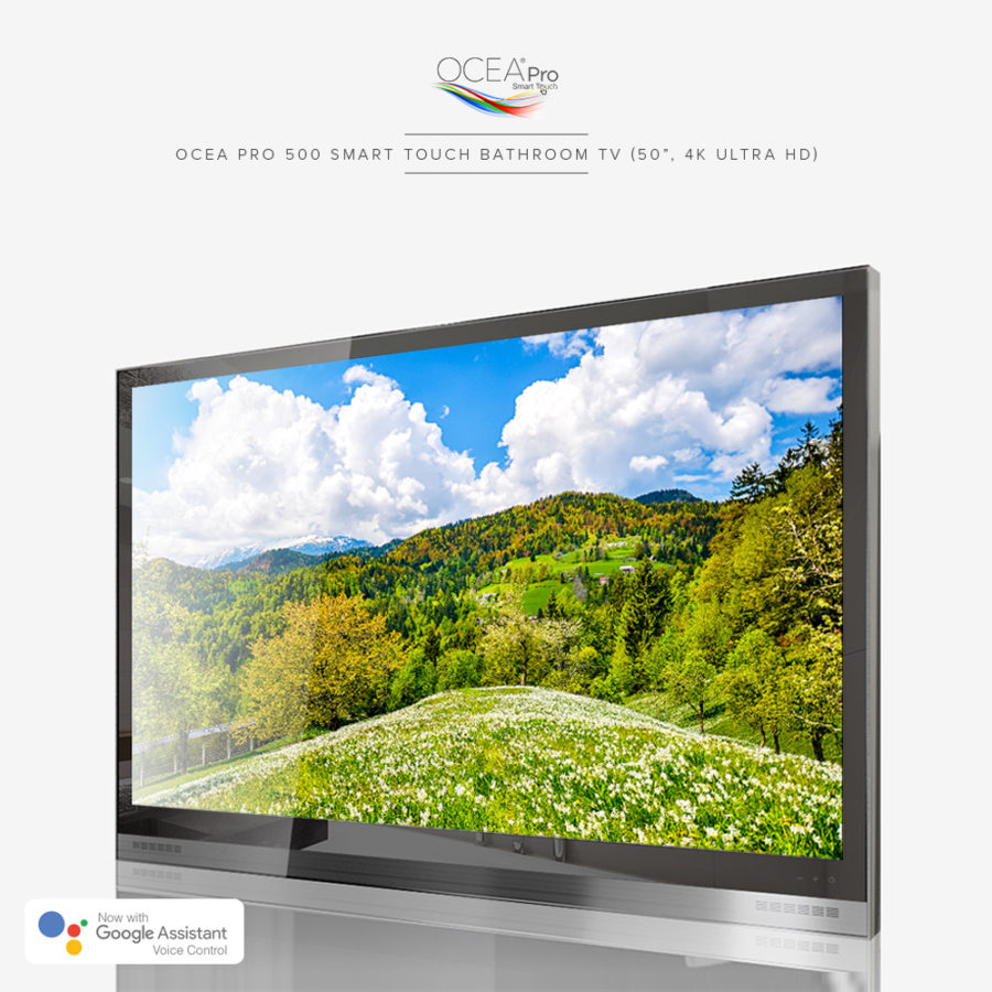 A black bathroom TV displaying a very clear and beautiful scenery of green hills and trees on its screen.